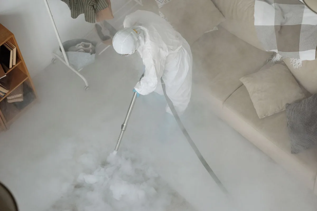 Biohazard cleanup technician in protective equipment, Lowell, MA